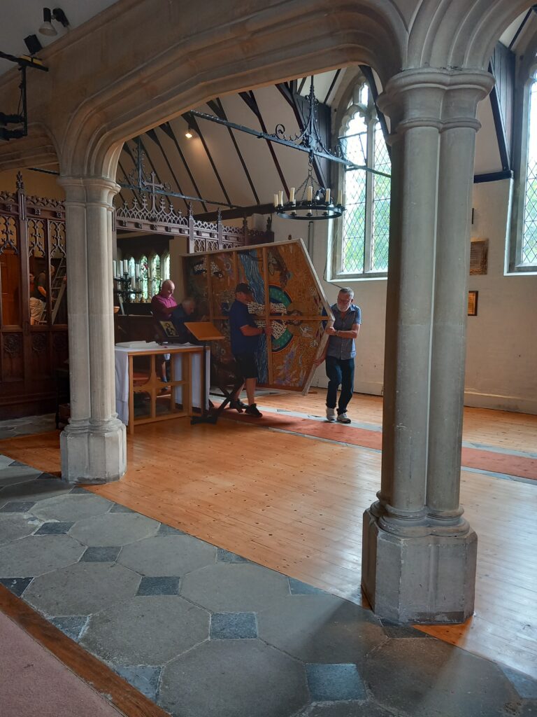 No pews. No chairs. Tha tapestry being carefully removed, the team not reading on the weak part of the floor